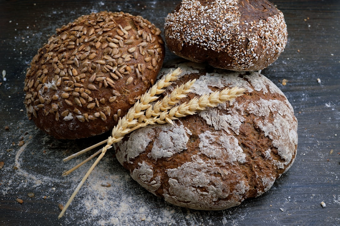 Rustic flour-dusted loaves with sesame and sunflower seed crusts